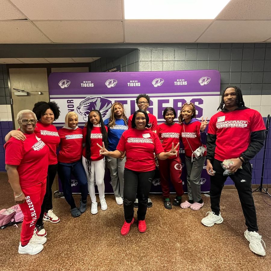The Democracy Trailblazers team in red shirts at a school gym